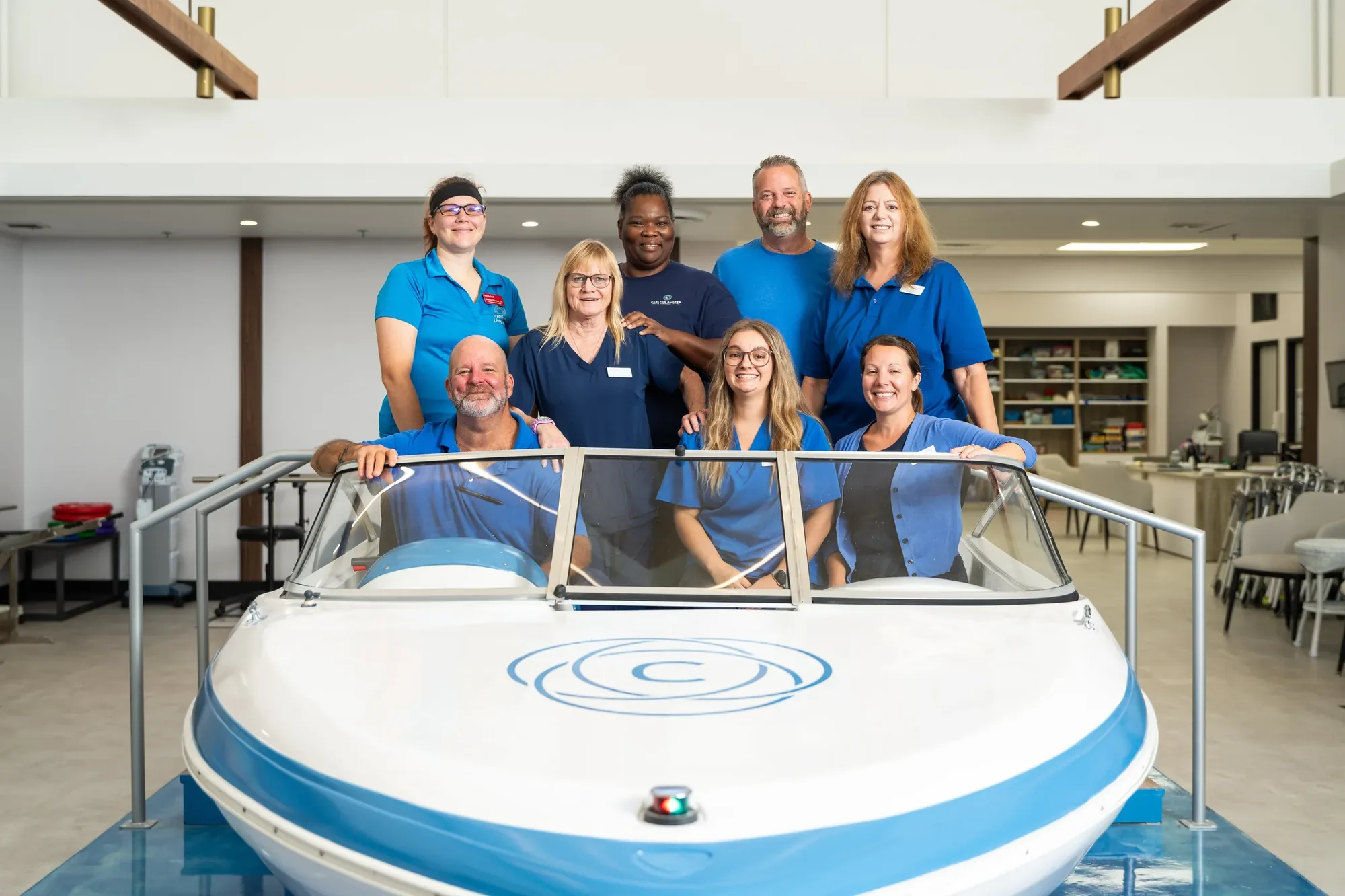 Carlton Shores — care team gathered around the therapy boat