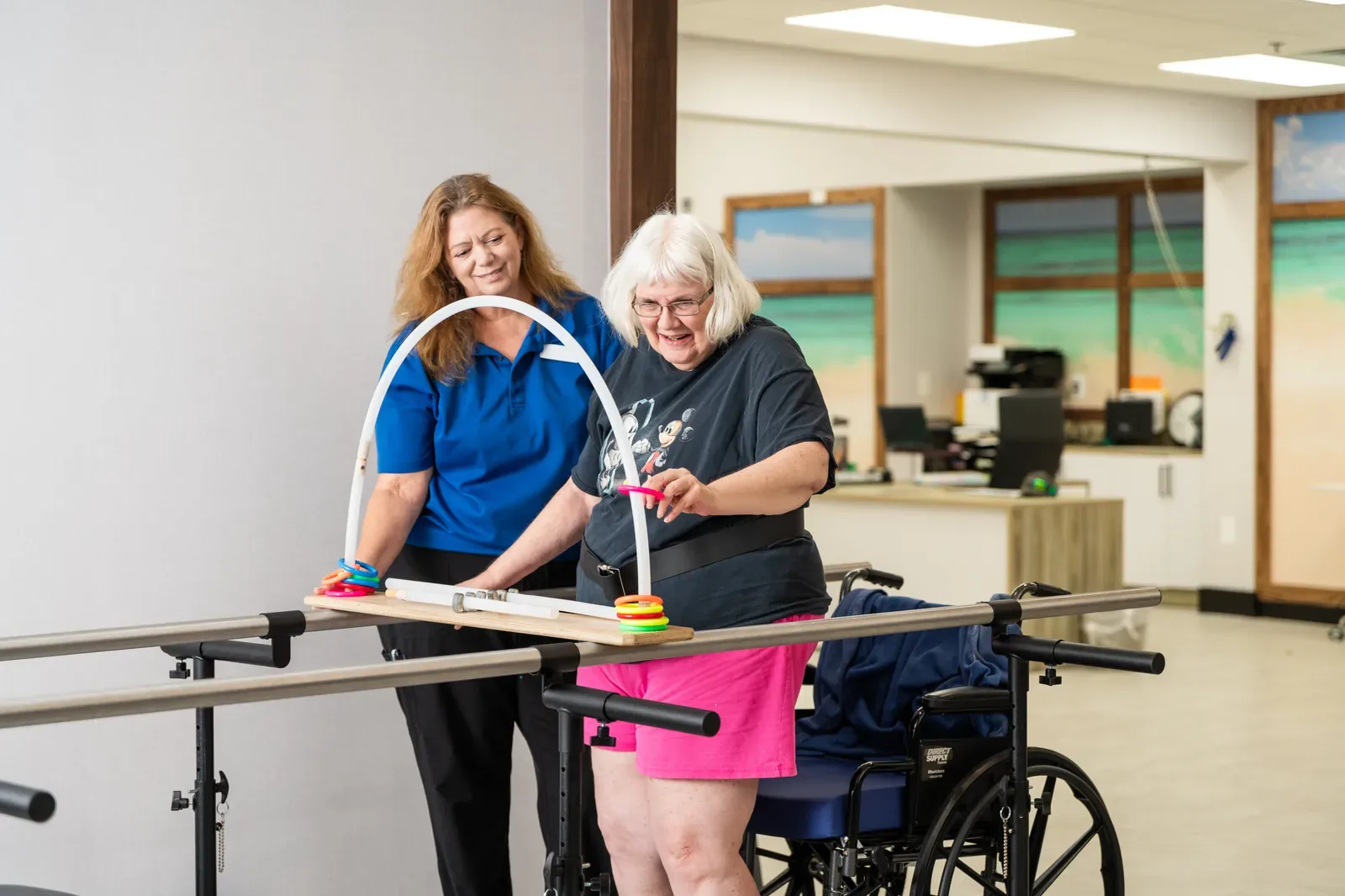 Carlton Shores — therapist helping a resident with a ring exercise