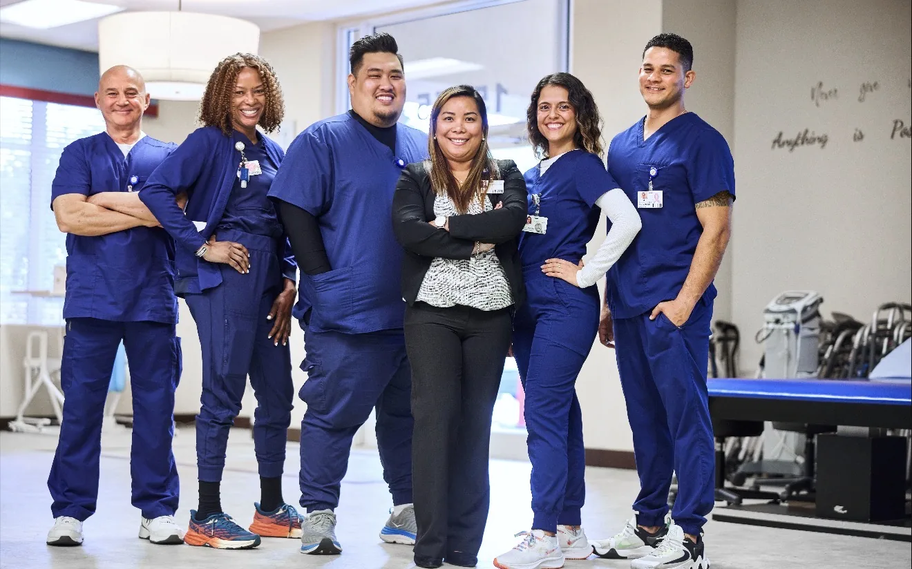 Glades West — therapy team in navy scrubs in the rehab gym